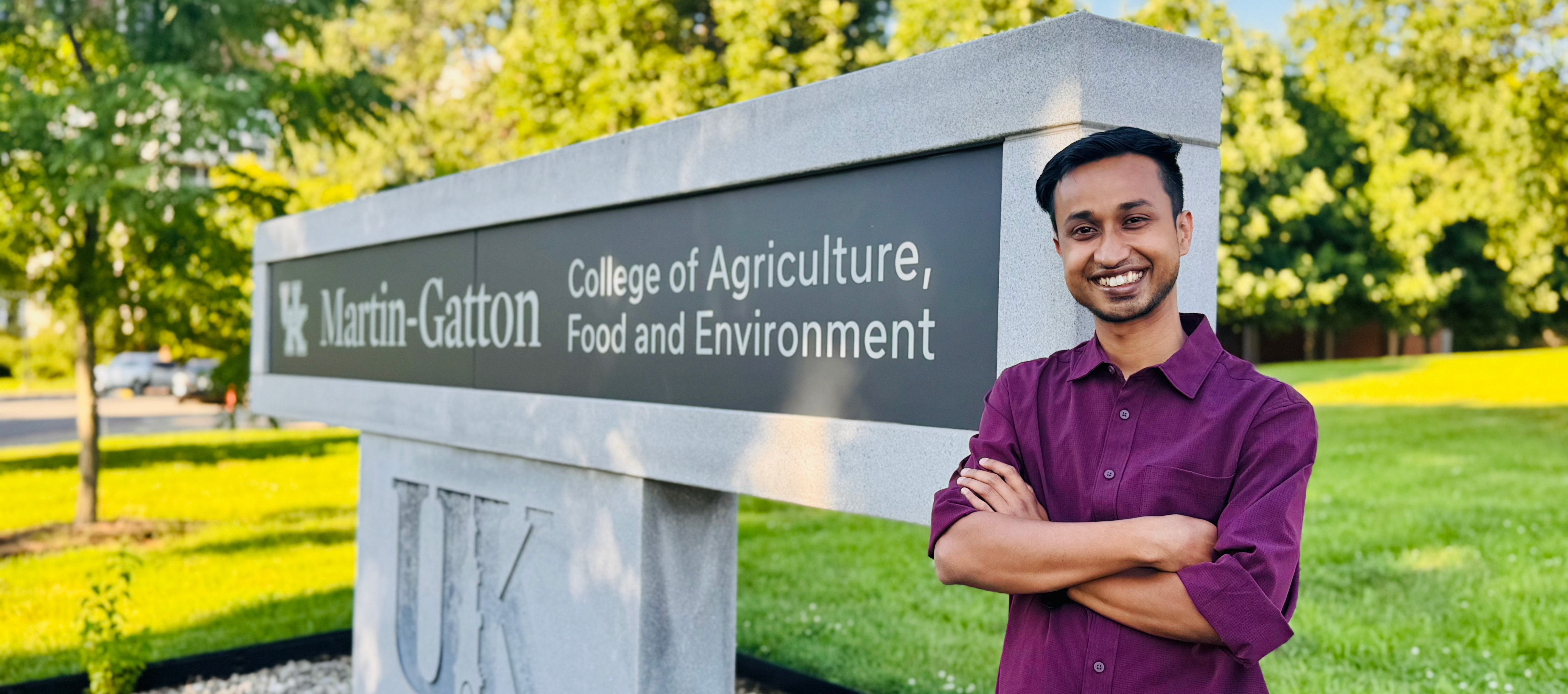 Manoj infront of CAFE logo landmark